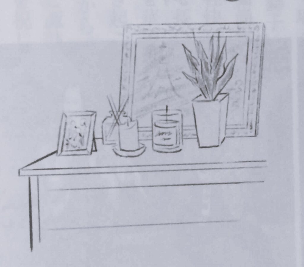 Sketch of a small table with a photo frame, room freshener sticks, two candles, and potted plant, in front of a larger picture of the Eiffel tower.